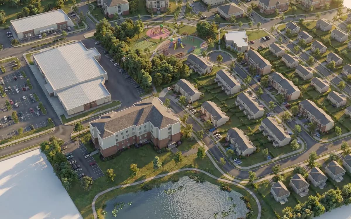 Vue aérienne du quartier présentée sur le site de Réserve Étoilée : habitations, rues, espaces verts et plans d’eau.